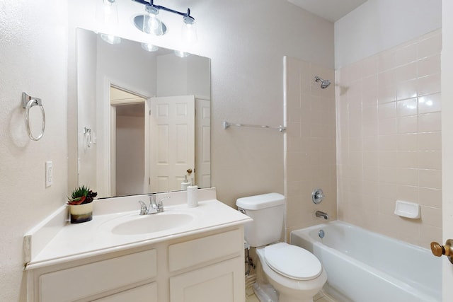 full bathroom with vanity, tiled shower / bath, and toilet