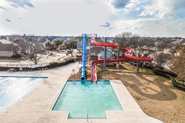 view of jungle gym featuring a community pool