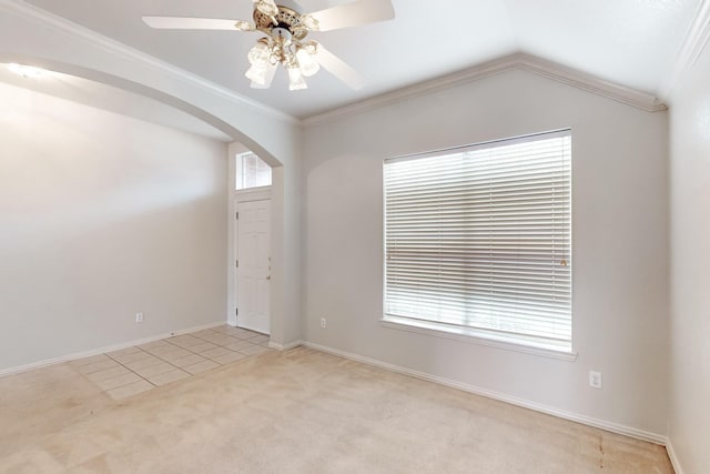 carpeted spare room with lofted ceiling, ornamental molding, and ceiling fan