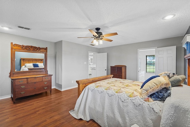 bedroom featuring a textured ceiling, dark wood-type flooring, and ceiling fan