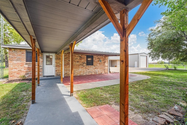 view of patio / terrace with a garage and an outdoor structure