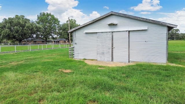 view of outbuilding with a lawn