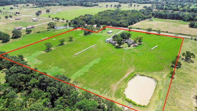 drone / aerial view featuring a water view and a rural view