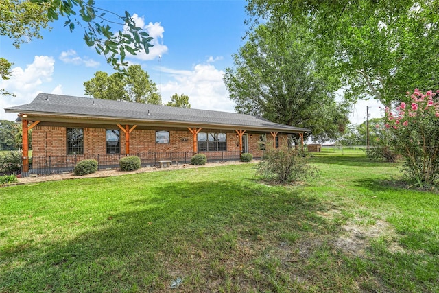 back of property featuring a lawn