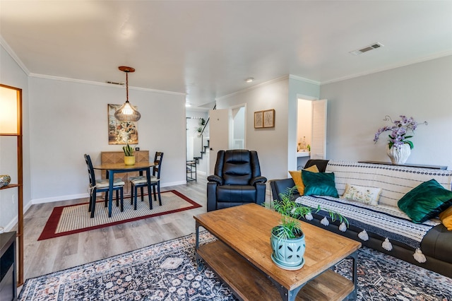 living room featuring hardwood / wood-style flooring and ornamental molding