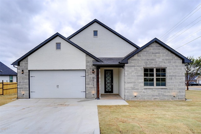 view of front of property featuring a garage and a front yard