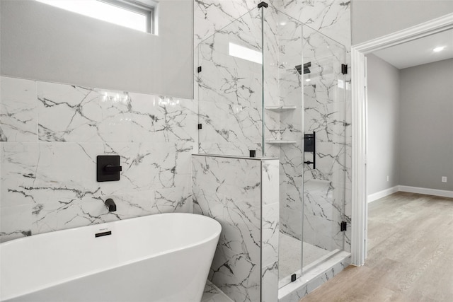 bathroom with wood-type flooring and separate shower and tub