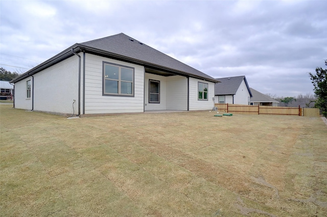 rear view of property featuring a yard