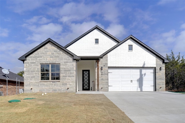 view of front of house with a garage and a front lawn