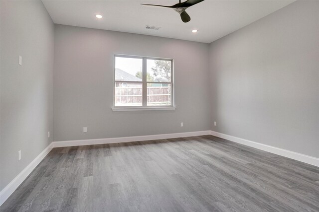 empty room featuring ceiling fan and hardwood / wood-style floors