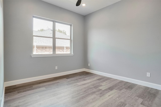 empty room featuring ceiling fan and light hardwood / wood-style floors