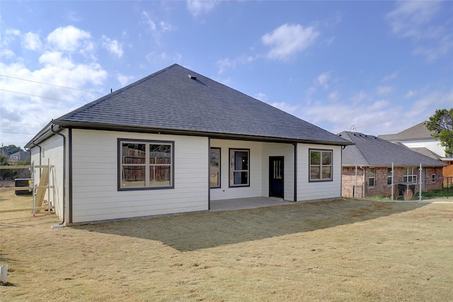 rear view of property with a yard and a patio area