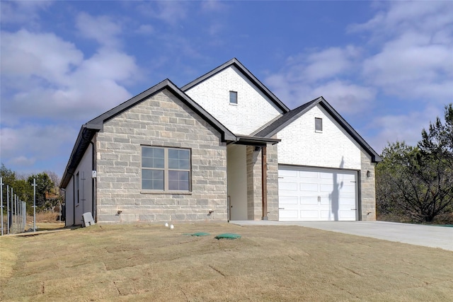 view of front of property featuring a garage and a front yard