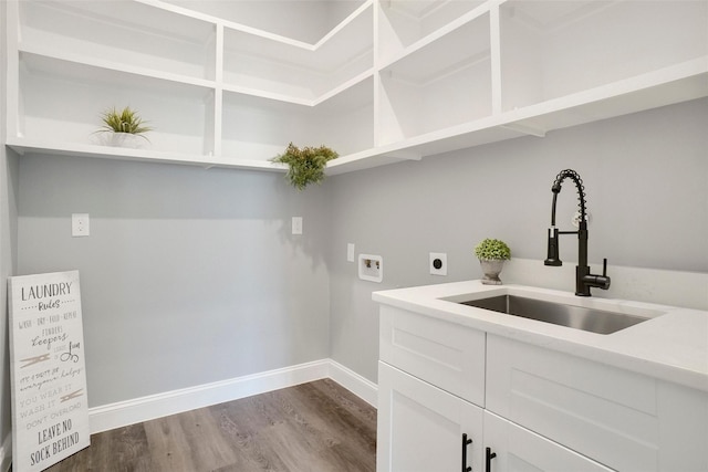 laundry area with wood-type flooring, sink, cabinets, washer hookup, and hookup for an electric dryer