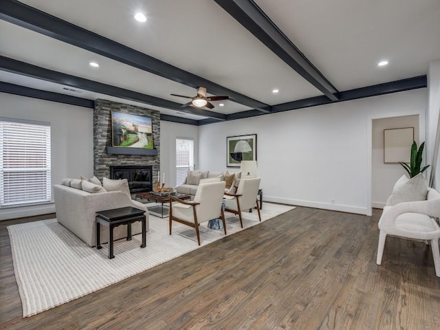 living room with a fireplace, beam ceiling, dark wood-type flooring, and ceiling fan