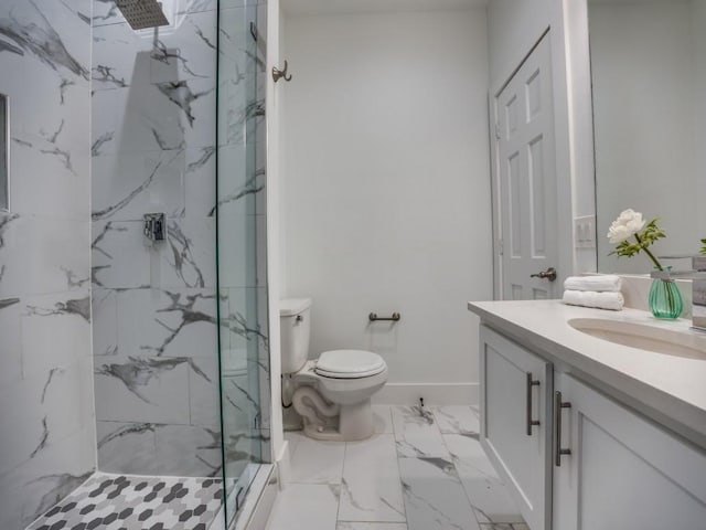 bathroom featuring vanity, a tile shower, and toilet