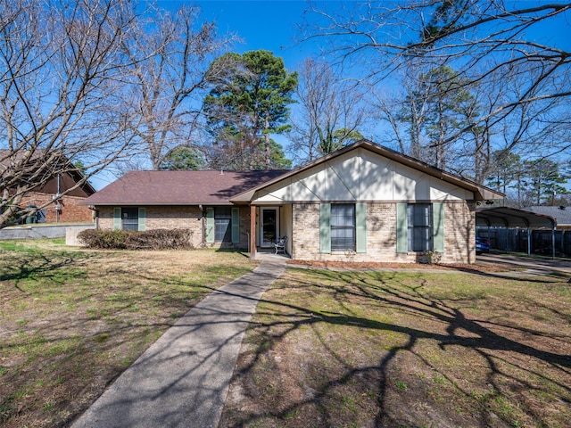 ranch-style house featuring a carport and a front yard