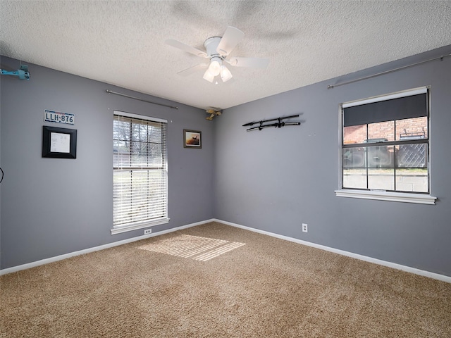 unfurnished room featuring a textured ceiling, ceiling fan, and carpet flooring