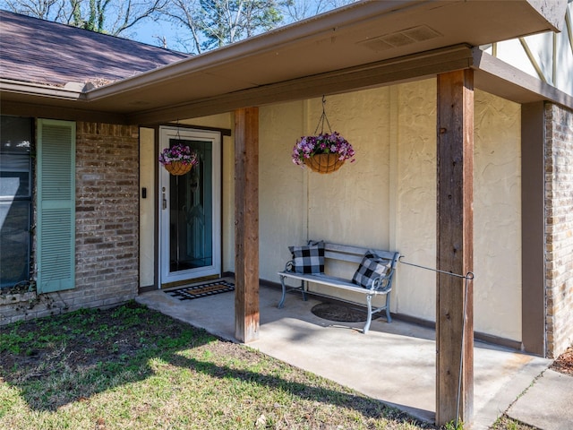 entrance to property with a patio