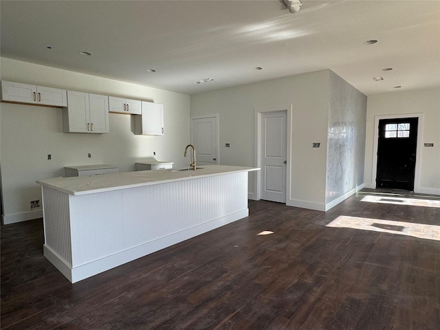 kitchen with white cabinetry, sink, a center island with sink, and dark hardwood / wood-style flooring