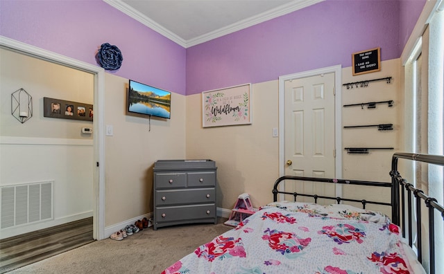 bedroom with ornamental molding and carpet