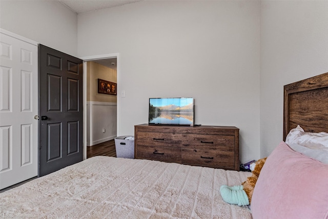 bedroom with dark hardwood / wood-style flooring