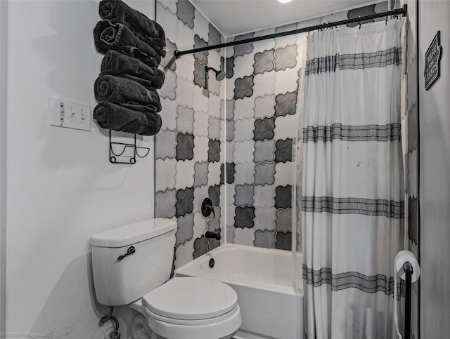 bathroom featuring shower / tub combo and toilet