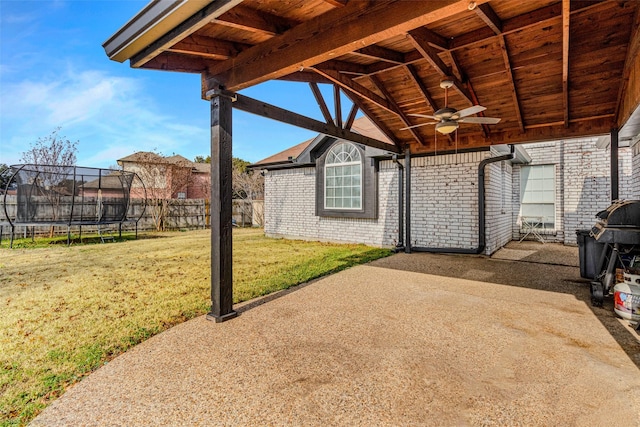 view of patio featuring a trampoline and ceiling fan