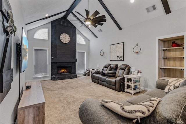 carpeted living room with built in features, ceiling fan, beam ceiling, high vaulted ceiling, and a brick fireplace