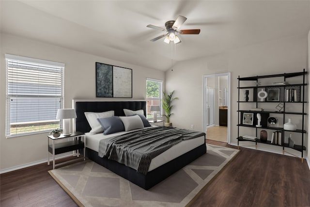 bedroom featuring hardwood / wood-style floors, vaulted ceiling, ceiling fan, and ensuite bathroom