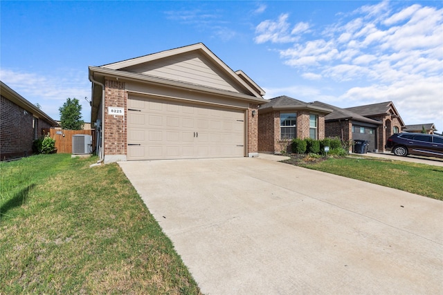 ranch-style house featuring central AC, a garage, and a front yard