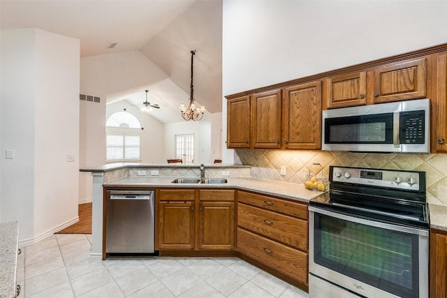 2601 Marsh Ln Unit 193, Plano, TX 75093 - living area featuring ceiling fan with notable chandelier, a high end fireplace, light wood finished floors, lofted ceiling, and visible vents