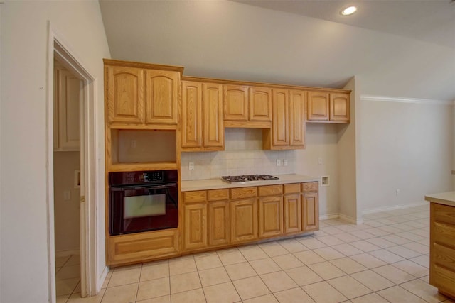 kitchen featuring light tile patterned floors, black oven, backsplash, stainless steel gas cooktop, and vaulted ceiling