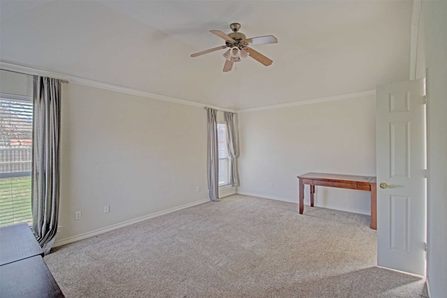 carpeted spare room featuring a wealth of natural light, ornamental molding, and ceiling fan