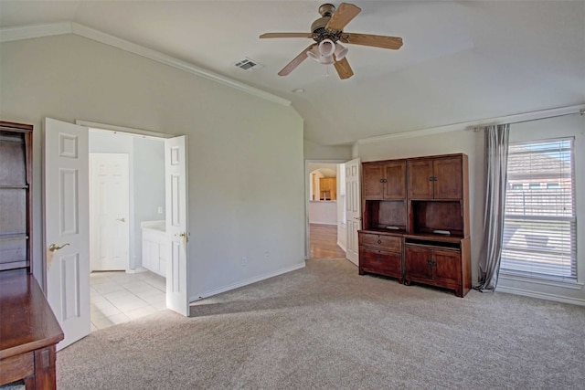 unfurnished living room with vaulted ceiling, ornamental molding, light carpet, and ceiling fan