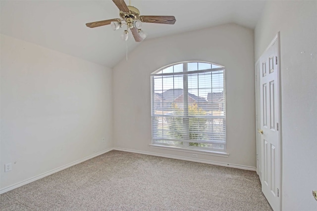 empty room featuring lofted ceiling, light carpet, and ceiling fan