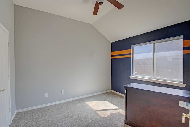 empty room with ceiling fan, light colored carpet, and lofted ceiling