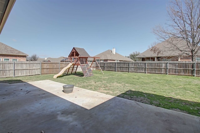 view of yard featuring a patio and a playground