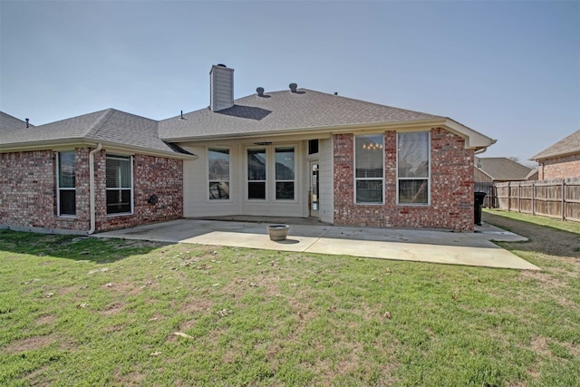 rear view of house with a lawn and a patio area