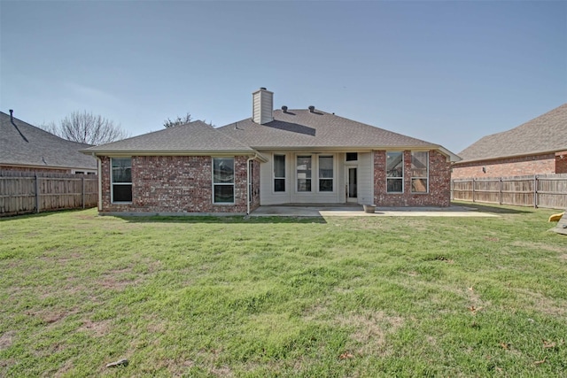 rear view of property with a patio area and a lawn