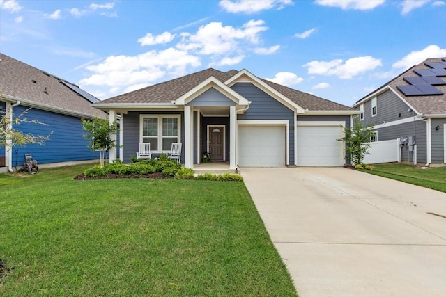 view of front of house with a garage, covered porch, and a front lawn