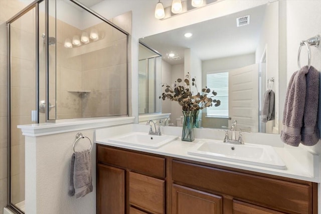 bathroom featuring vanity and an enclosed shower