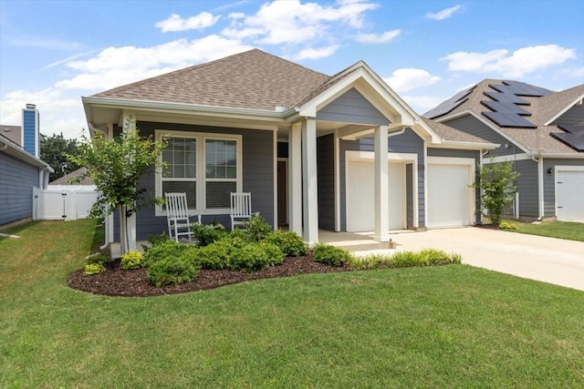 craftsman house with a porch, a garage, and a front lawn