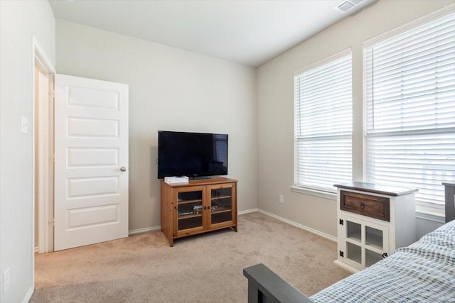 bedroom featuring light carpet