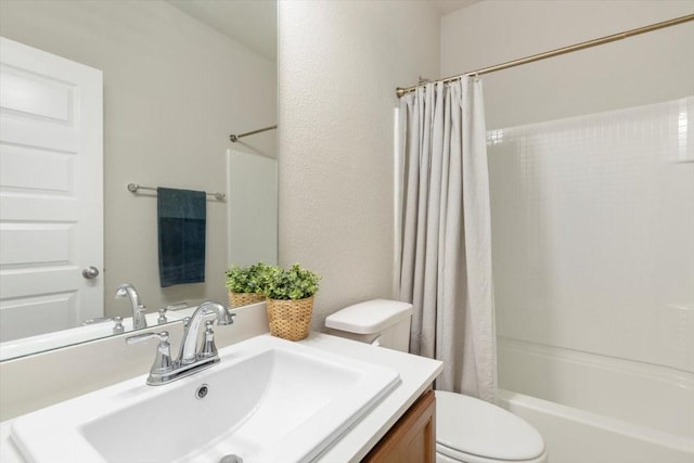 full bathroom featuring shower / bath combo, vanity, and toilet