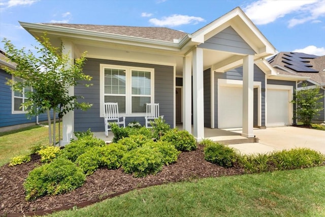 view of front of property featuring a garage and covered porch