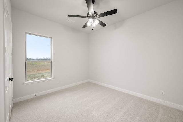 empty room with light carpet, baseboards, visible vents, and ceiling fan