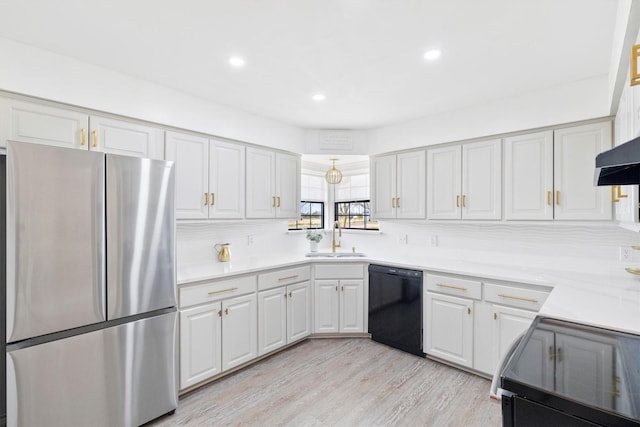 kitchen featuring white cabinetry, sink, backsplash, black appliances, and light wood-type flooring