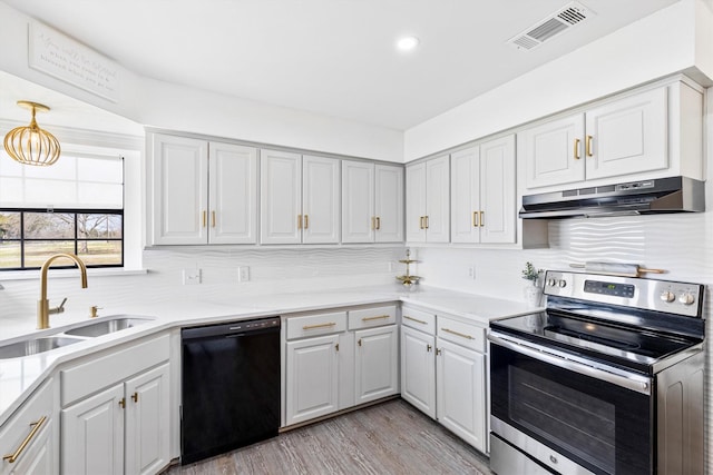 kitchen with electric stove, sink, dishwasher, decorative backsplash, and light wood-type flooring