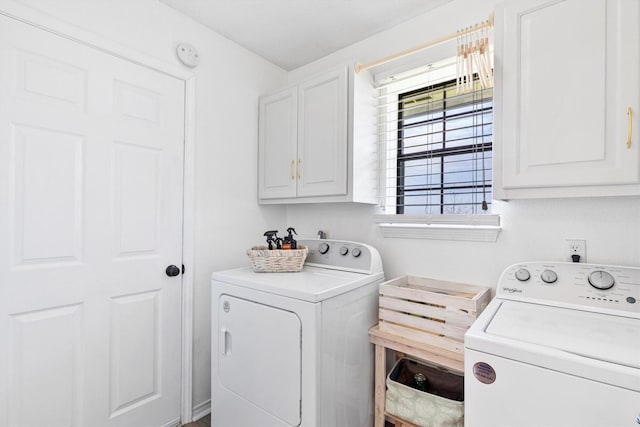 washroom featuring cabinets and washer and dryer